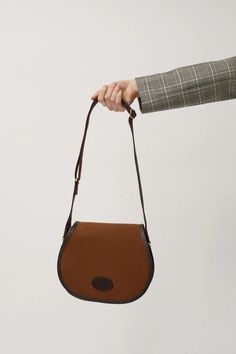 Brady Aire Bag in Hazel Brown Brown Coated Canvas Saddle Bag, Brown Canvas Shoulder Bag With Leather Backing, Classic Coated Canvas Saddle Bag With Detachable Strap, Luxury Canvas Bags With Leather Lining, Classic Coated Canvas Bags For Fall, Leather Travel Bags With Twill Lining, Luxury Leather Trim Saddle Bag For Travel, Luxury Brown Saddle Bag With Leather Trim, Luxury Saddle Bag With Leather Trim For Travel