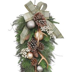 a christmas wreath with pine cones, balls and deer antlers hanging from it's side