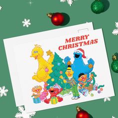 the sesame street christmas card is surrounded by ornaments