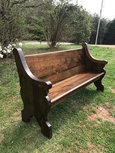 an old wooden bench sitting in the grass