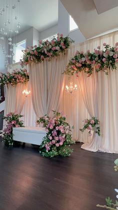 a room decorated with flowers and chandeliers