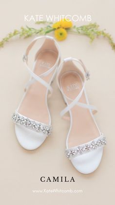 the bride's shoes are all white and have crystal embellishments