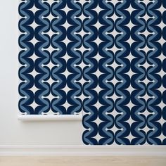 a blue and white wallpaper with an abstract design on the wall next to a window