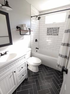 a white toilet sitting next to a sink in a bathroom