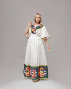 This ሀበሻ Kemis is a true masterpiece of Ethiopian fashion that features a unique and intricate Tilf design. The Tilf design is a beautiful and traditional Ethiopian pattern that adds a touch of uniqueness and sophistication to the overall design. The dress is elegant and sophisticated, with a flattering and comfortable fit that accentuates the beauty of the wearer. The Tilf design on the dress is intricate and beautiful, a testament to the skill and craftsmanship of Ethiopian artisans. The dress Bohemian Dress With Woven Motifs For Transitional Seasons, Bohemian Dresses With Traditional Patterns For Transitional Season, White Dress With Traditional Patterns For Eid, Festive White Dresses With Woven Motifs, Festive White Dress With Woven Motifs, Traditional White Maxi Dress For Transitional Season, Folk Style Dresses With Woven Motifs For Festive Occasion, Multicolor Dresses With Woven Motifs For Festivals, White Dresses With Traditional Patterns For Transitional Season