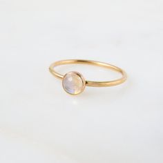 Our dainty Moonstone Ring features an absolutely stunning natural stone with reflects of blue. Moonstone is the birthstone for all our June-born babes. Don't know your ring size? Ring Size Guide or Buy Ring Sizer …………………………………. Details: Stone is Natural Rainbow Moonstone measuring 5mm Available in 14k Gold Filled or Sterling Silver Waterproof and can be worn everyday Size Inclusive and made to order About Your Jewelry If you are not wearing your jewelry it is best to store it in a cool, dry plac Gold Gemstone Ring, Blue Moonstone, Argentium Silver, Natural Rainbow, Ring Sizer, Moonstone Ring, Ring Size Guide, Rainbow Moonstone, Sterling Ring