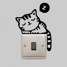 a light switch with a cat sleeping on it's side and an arrow pointing to the left