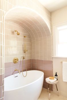 a white bath tub sitting next to a window