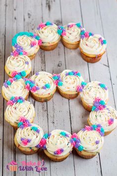 cupcakes are arranged in the shape of a heart