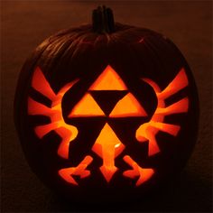 a carved pumpkin with the legend of zelda symbol on it's face and hands