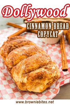 cinnamon bread is sitting on top of a red and white checkered napkin with cinnamon sticks