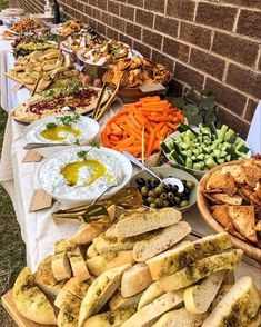 a long table filled with different types of food and dips on top of it