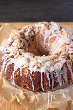 a glazed donut sitting on top of a piece of wax paper covered in icing