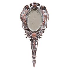 an ornately decorated wall mounted mirror on a white background