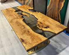 a table made out of wood with metal legs on display in a store or showroom