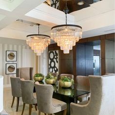 an elegant dining room with chandelier and chairs