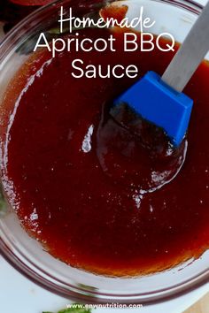 homemade apricot bbq sauce in a glass bowl with a blue spatula