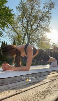 a woman is doing push ups on a bench