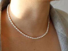 This Pearl Strand Necklace celebrates a classic piece of jewelry fit for all ages. The timeless pearls lined on a strand can be worn on its own or can be easily layered with our Pearl Circle Necklace. Wear this necklace to any occasion for a touch of sophistication. Details:-The length of the Pearl Strand Necklace is 16 inches + 2 inch extender chain-Option to select gold vermeil or sterling silver findings -Natural fresh water pearls-Pearls measure approximately 3-4mm in diameter-Metal thread for the ultimate quality and durability SHIPPING & PACKAGING All items come packaged in a small jewelry box which is perfect for when buying as a gift for a friend or that special someone. Classic Pearl Beaded Necklaces With Pearl Chain, Classic Pearl Beaded Necklace With Pearl Chain, Classic Single Strand Beaded Necklaces, Classic Single Strand Beaded Necklace For Everyday, Classic Pearl Embellished Beaded Necklaces For Gift, Classic Pearl Embellished Beaded Necklace As Gift, Classic Pearl Embellished Beaded Necklace For Gift, Classic Pearl White Beaded Necklace With Pearl Drop, Classic Beaded Necklaces With Round Beads