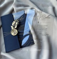 a blue and silver wedding suite with a gold brooch