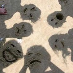 several people are standing in the sand with their footprints