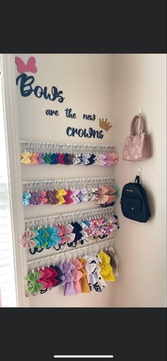 there are many bows on the wall in this child's room, and one has a handbag hanging from it