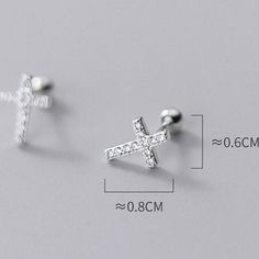 Sold as a pair. Post length: 7-8 mm Materials: 925 sterlings silver, cubic zirconia Screw ball back design made these cross earrings comfortable to wear at night and at different location such as cartilage. Simple, dainty, minimalist cross design Jewelry Care: See more information about how to care for your jewelry here. Shipping Policy: Orders will be shipped within 1-3 business days. Economy shipping will take 7-14 days to arrive and standard shipping is 1- 4 days for U.S. orders. Internationa Cross Stud Earrings, Cross Earrings Studs, Cross Design, Cross Earrings, Sterling Silver Cross, Cross Designs, Cartilage Earrings, Silver Cross, Back Design