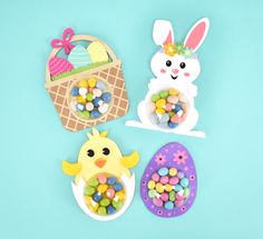 three easter decorations on a blue background with eggs and candies in the shape of an egg