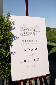 a welcome sign for the wedding of adam and britini in front of a house