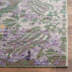 an area rug with purple and green colors