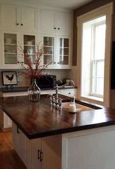 a kitchen with white cabinets and black counter tops, has the words amazing kitchen remodel for under $ 650