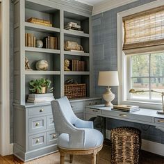 a home office with built - in bookcases and wicker baskets on the desk