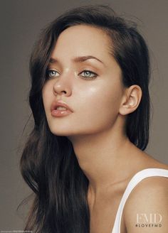 a woman with long hair and blue eyes posing for a magazine cover photo by photographer