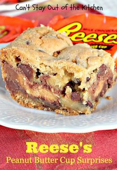 a piece of peanut butter cup cake on a white plate with reese's candy bar in the background