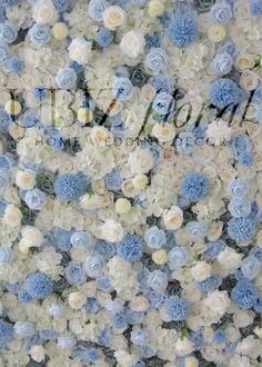 blue and white flowers are arranged on the wall