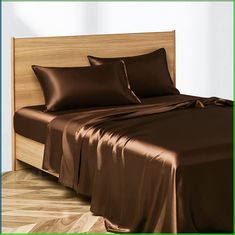 a bed with brown sheets and pillows on it