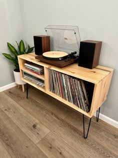 a record player sitting on top of a wooden shelf