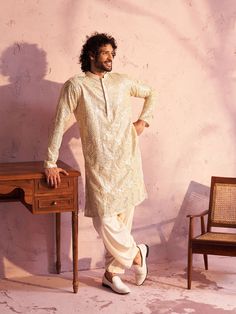 Vastramay Men's Cream Georgette Embellished Kurta A classic choice for any occasion, this cream georgette kurta is elegantly embellished for a sophisticated look. Crafted with care, it offers both style and comfort. Key Features: Cream colored georgette fabric Embellished design for a touch of elegance Mandarin collar Long regular sleeves Straight cut, knee-length silhouette Specifications Sleeve Length - Long Sleeves Top Shape - Straight Top Hemline - Straight Top Length - Knee Length Neck Mand Cream Semi-stitched Wedding Kurta, Ceremonial Cream Long Sleeve Kurta, Floor-length Semi-stitched Cream Kurta, Cream Embroidered Straight Kurta Bandhgala, Ceremonial Cream Jamawar Kurta, Georgette Kurta, Men Cream, Sophisticated Look, Sleeves Top