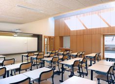 an empty classroom with desks and chairs