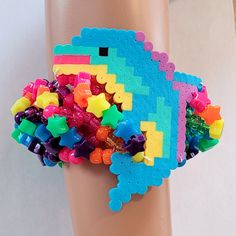 As seen on my YouTube channel Kandi Toybox. You can watch me create this beautiful piece on YT!  Size 9-10 inches  This kandi cuff is made with rainbow pony beads, rainbow stars and dolphin perler. This Item is premade and is ready to ship! Perfect for any event! You will get lots of compliments in this unique wearable art! Stand out at your next event! Birthday party  Edm festival  Raves Rave outfit  Festival outfit Pride Rave birthday  Rave anniversary  Pride Rave gift Handmade Plastic Bracelets For Festival, Adjustable Multicolor Rave Wristband, Handmade Fun Beaded Plastic Bracelets, Handmade Fun Plastic Beaded Bracelets, Rave Style Festival Beaded Bracelets With Colorful Beads, Rave Style Colorful Beaded Bracelets For Festival, Rave Style Plastic Jewelry For Festivals, Fun Rainbow Bracelets For Parties, Fun Rainbow Bracelets For Party