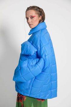 Unisex quilted jacket "Lupinus Light Blue" features a round shoulder and oversized fit for a relaxed, comfortable feel. It's made from lightweight, wrinkle-free polyester and has large pockets, windproof, and water repellent properties. The soft, bold shape makes it a statement piece, and the hypoallergenic synthetic padding adds warmth without compromising style.Size Guide:ONE SIZE (fits to XS-XL)Collar - 51 cmWides middle line - 170 cmBottom line - 140 cmSleeve ends - 57 cmLength from the neck Blue Quilted Jacket For Fall Outdoor, Blue Quilted Jacket For Fall Outdoor Activities, Blue Quilted Jacket For Outdoor Fall Activities, Long Sleeve Quilted Puffer Jacket For Outdoor, Blue Nylon Puffer Jacket For Fall, Oversized Quilted Outerwear For Cold Weather, Quilted Long Sleeve Puffer Jacket For Outdoor, Nylon Puffer Windbreaker With Long Sleeves, Blue Puffer Outerwear For Outdoor Activities