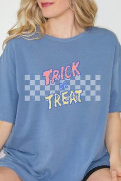 Embrace the Halloween vibe with our retro-inspired graphic tee. This adorable and vibrant T-shirt effortlessly combines nostalgia and playfulness. Ideal for the season, it's the ultimate choice for a stylish trick-or-treat experience. Grab yours today! Halloween Cotton T-shirt With Text Print, Halloween Blue Tops With Letter Print, Blue Halloween Top With Letter Print, Blue Halloween Tops With Letter Print, Blue Halloween Letter Print Tops, Blue Letter Print Top For Halloween, Trendy Halloween Text Print T-shirt, Halloween Graphic Print Relaxed Fit T-shirt, Blue Pre-shrunk Tops For Halloween