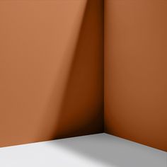 the corner of a room with an orange wall