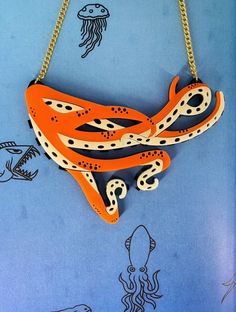 Octopus  🐙 necklace is a fun piece to pair with your outfit. It is a striking piece that will get you noticed for all the right reasons. The necklace is made from cut out black perspex with orange and cream acrylic layered on top. It is linked to a curb chain with jump rings.  If you have any questions drop us a line!💌We are more than happy to help😁 To clean your necklace you can simply wipe with a glasses cloth or soft cloth to remove finger marks. Acrylic is a fragile material so please store in a jewellery box to prevent damage.  As ever for safety please keep away from small children. Bold Resin Jewelry For Gifts, Bold Resin Jewelry For Gift, Playful Orange Party Jewelry, Unique Hand Painted Orange Necklace, Unique Orange Necklace For Party, Perspex Jewelry, Plastic Jewellery, Octopus Necklace, Acrylic Jewelry