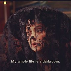 an image of a woman with black hair and words on her face that says, my whole life is a darkroom