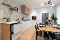 the kitchen is clean and ready to be used for dinner or lunchtime, while the dining table is set with place settings