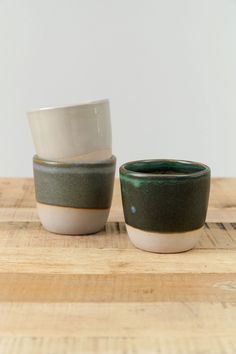 three bowls sitting on top of a wooden table