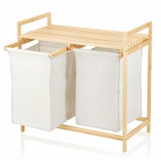 two white laundry hampers on a wooden stand