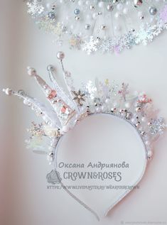 the tiara is adorned with crystal and pearl flowers, pearls, and snowflakes