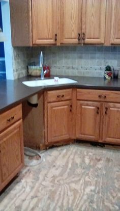 an unfinished kitchen with wooden cabinets and granite counter tops in the process of remodeling